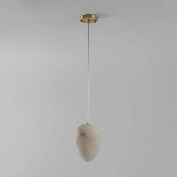 Decorative pendant lamp, brass finish, sculptural pebble, for ambient and modern home lighting.