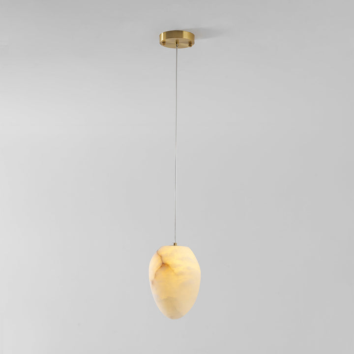 Brass finish sculptural pebble pendant light, modern ambient lighting for sophisticated spaces.