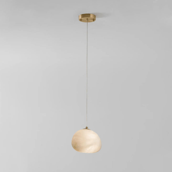 Brass pebble pendant light, sculptural design, a modern ambient lighting solution for homes.