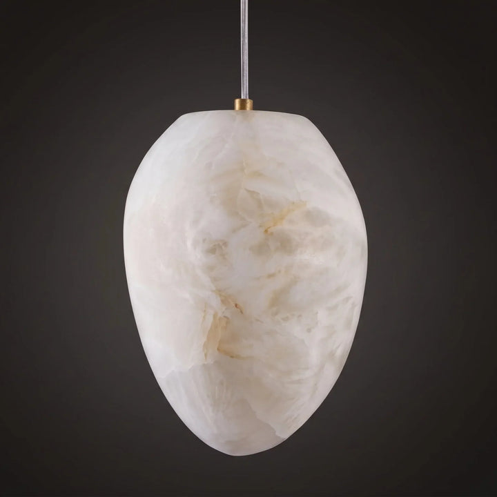 Serene spaces modern lighting: sculptural pebble pendant, brass finish, Japandi style.