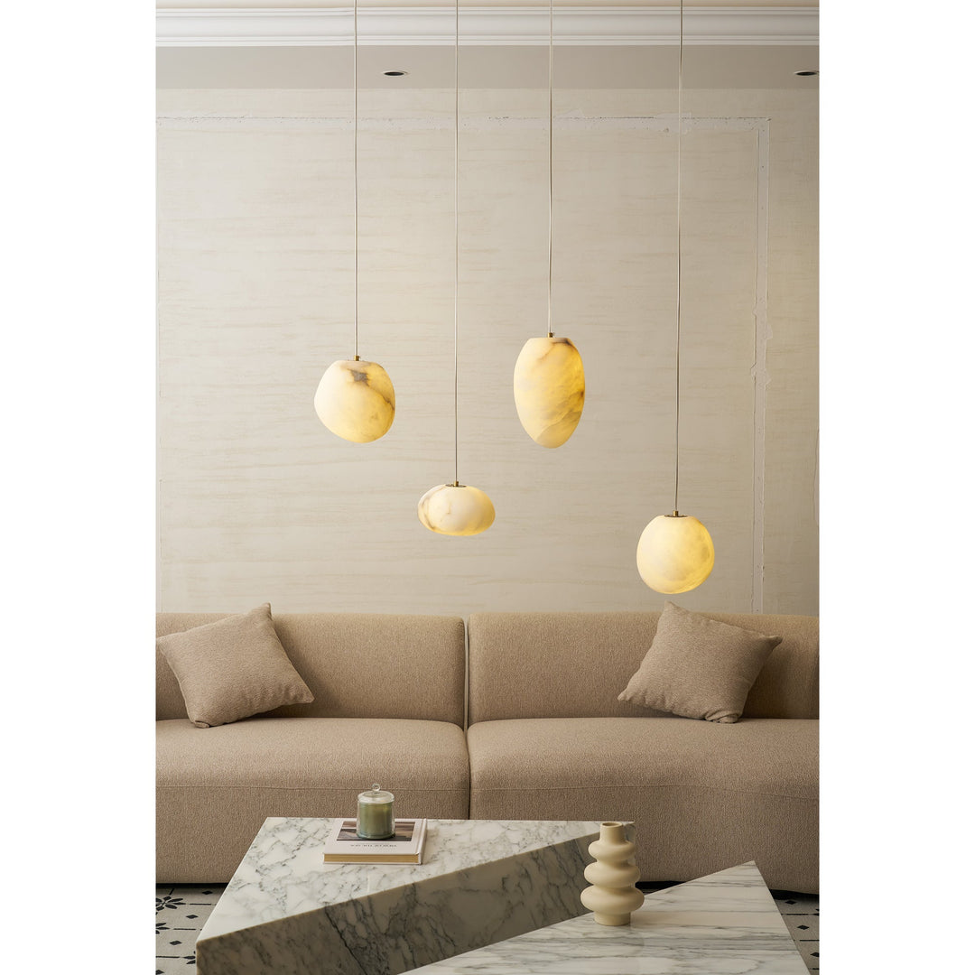 Japandi style ceiling lamp: a brass sculptural pebble pendant for serene, ambient lighting.