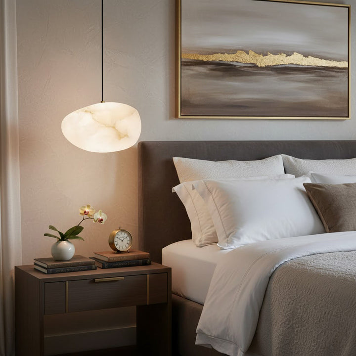 Ambient lighting: a brass sculptural pebble pendant light, modern and decorative for home decor.