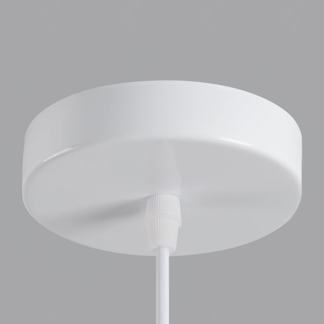 Dining room ambient light, sculptural tiered pendant, warm neutral beige.