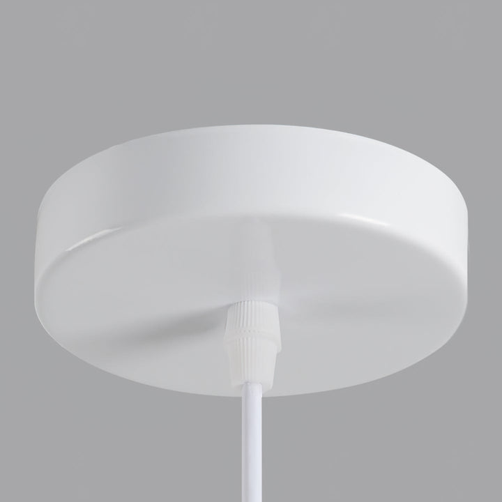 Dining room ambient light, sculptural tiered pendant, warm neutral beige.