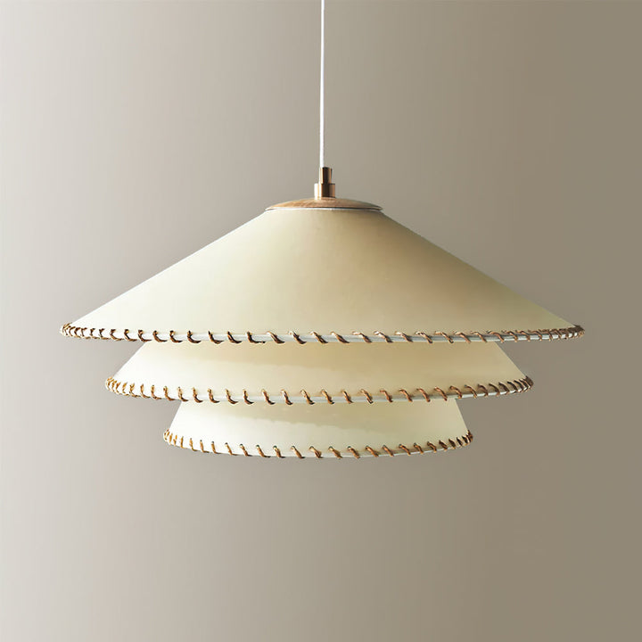 Beige tiered pendant lamp for dining room, sculptural design, ambient lighting, modern decor.