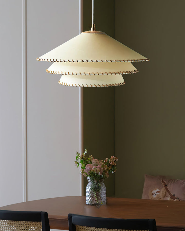 Sculptural tiered pendant light, warm neutrals, ambient glow for a cozy home.