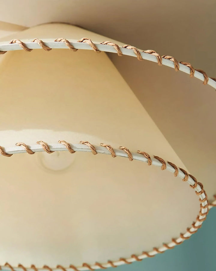 Beige tiered pendant light, modern sculptural design, ambient glow, home decor accent.