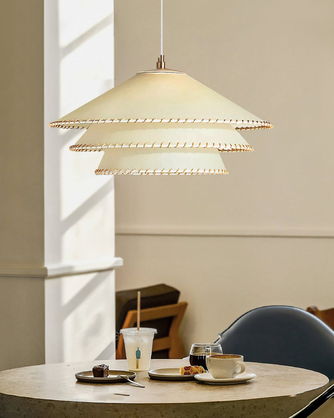 Modern sculptural tiered pendant light in beige, perfect for entryway ambient lighting.