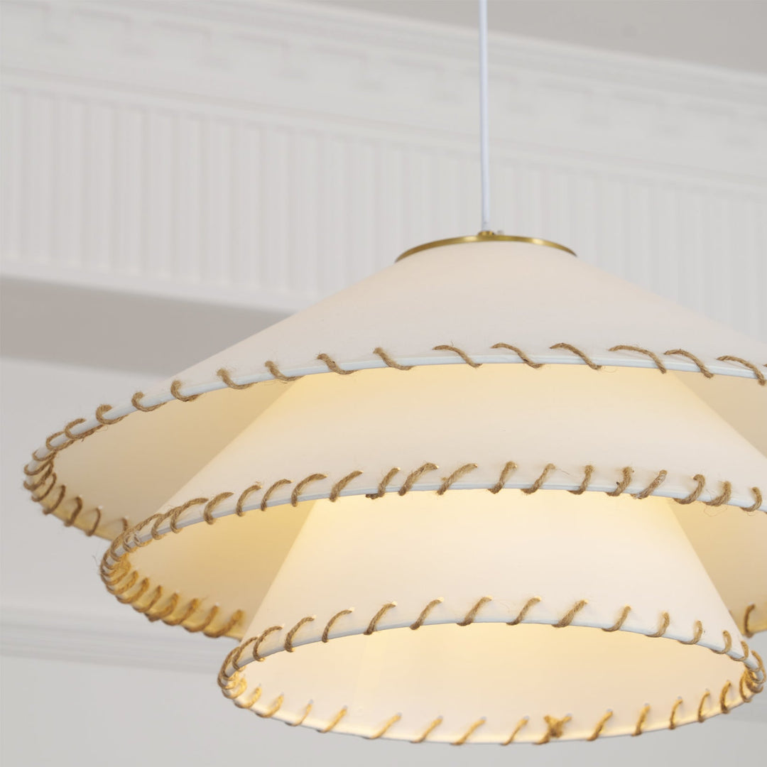 Entryway pendant light, modern sculptural tiered design, warm neutral ambient lighting.