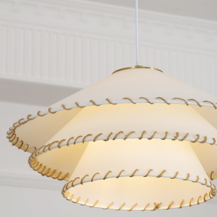 Entryway pendant light, modern sculptural tiered design, warm neutral ambient lighting.