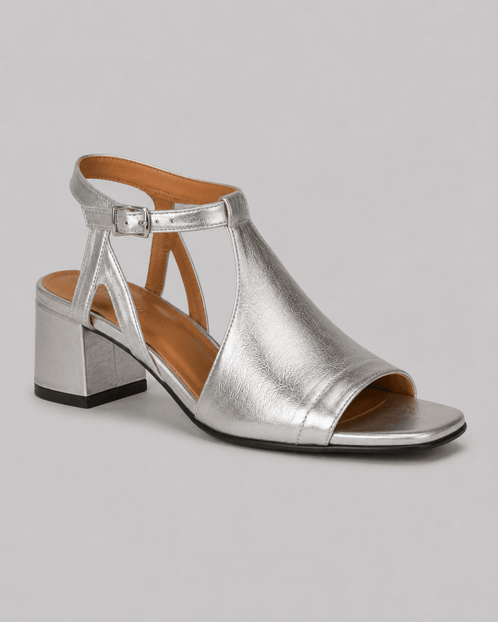 Women's shimmering silver cross-strap block heel sandals, ideal for comfortable party & summer wear.