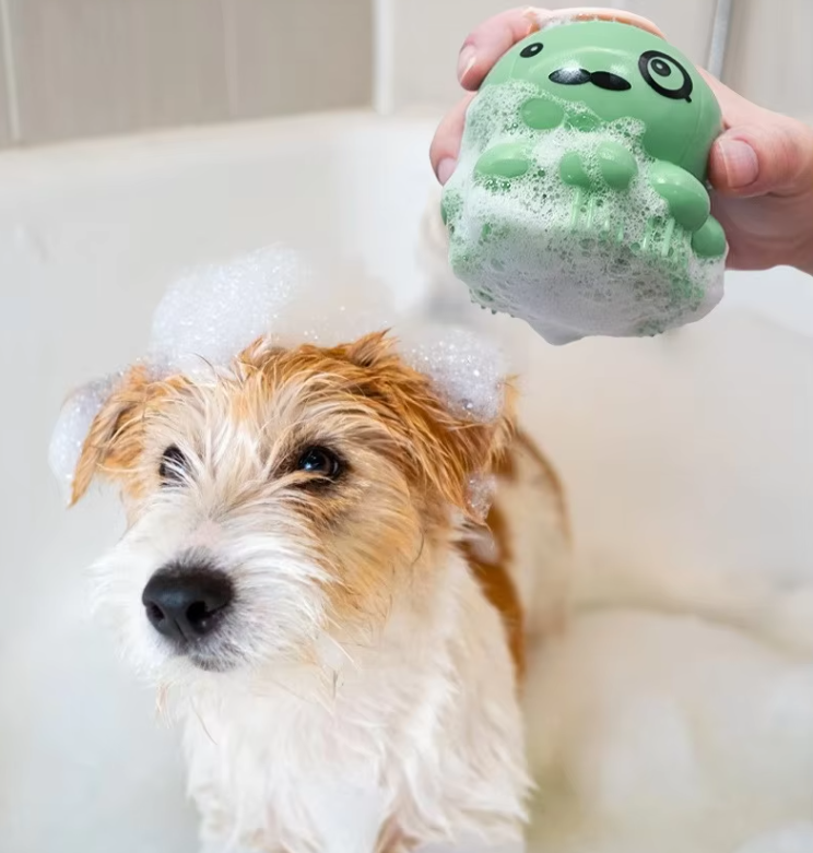 Silicone dog grooming bath brush with built-in foam dispenser for easy bathing and shedding.