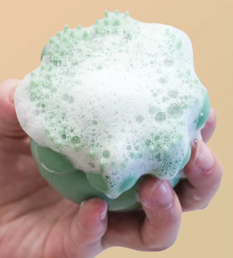 Pet grooming tool: silicone bath brush with foam dispenser for easy, mess-free dog & cat washing.
