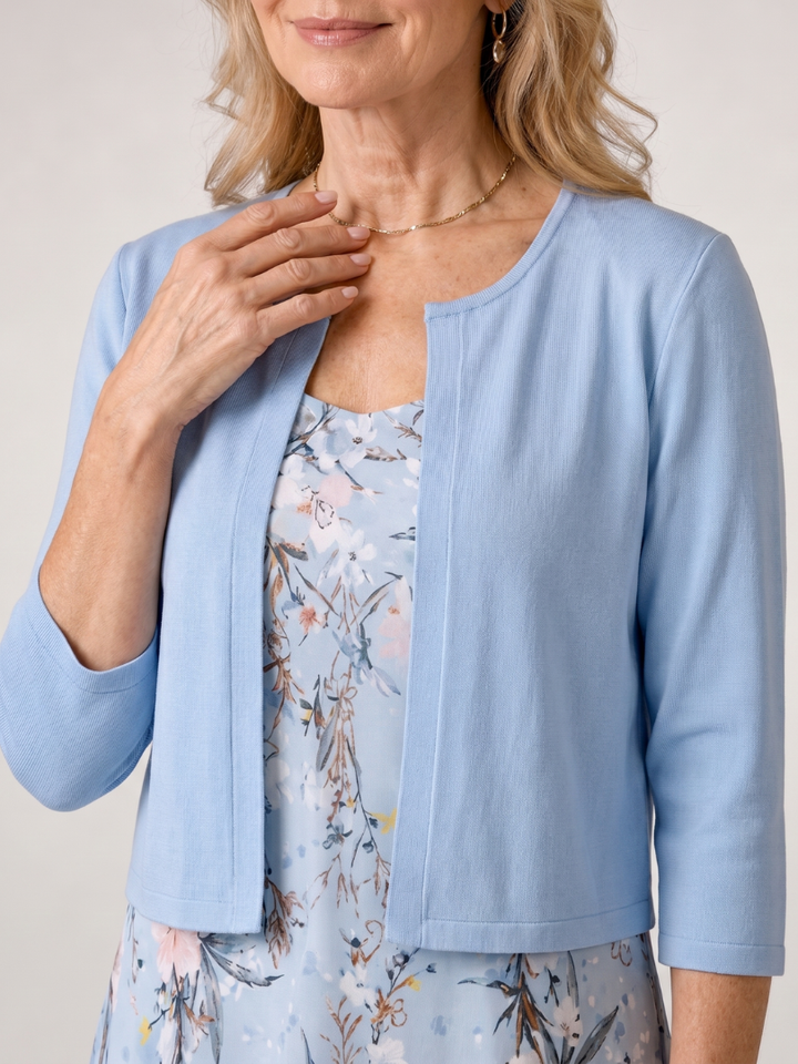 Sleeveless floral print midi dress and cropped jacket for women. Versatile two-piece set, ideal for elegant daytime wear.