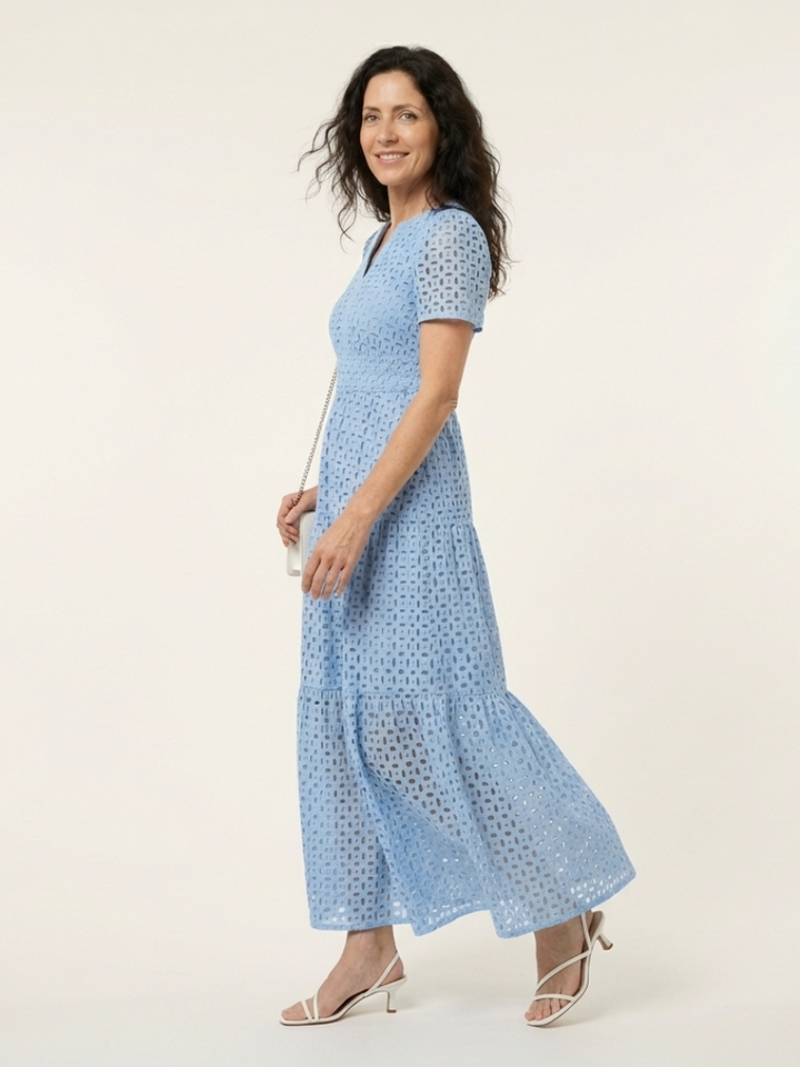 Women's sky blue eyelet tiered midi dress with V-neck, short sleeves, and smocked waist.
