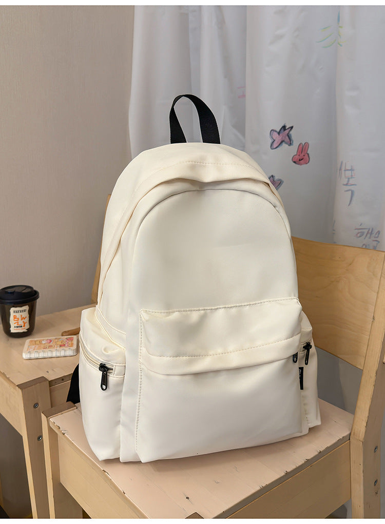 Sleek black minimalist unisex backpack for school, travel, and daily commute. Functional design with laptop compartment.