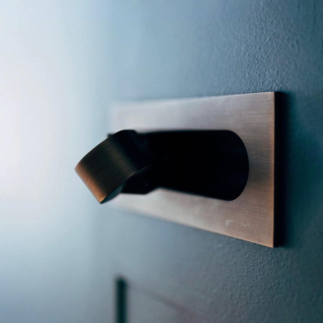 Wall-mounted LED reading lamp, adjustable, contemporary design, great for small spaces.
