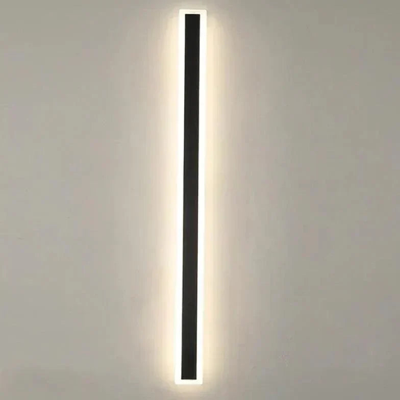 Modern LED exterior wall light installed on a home's patio, providing warm, dimmable outdoor garden illumination.
