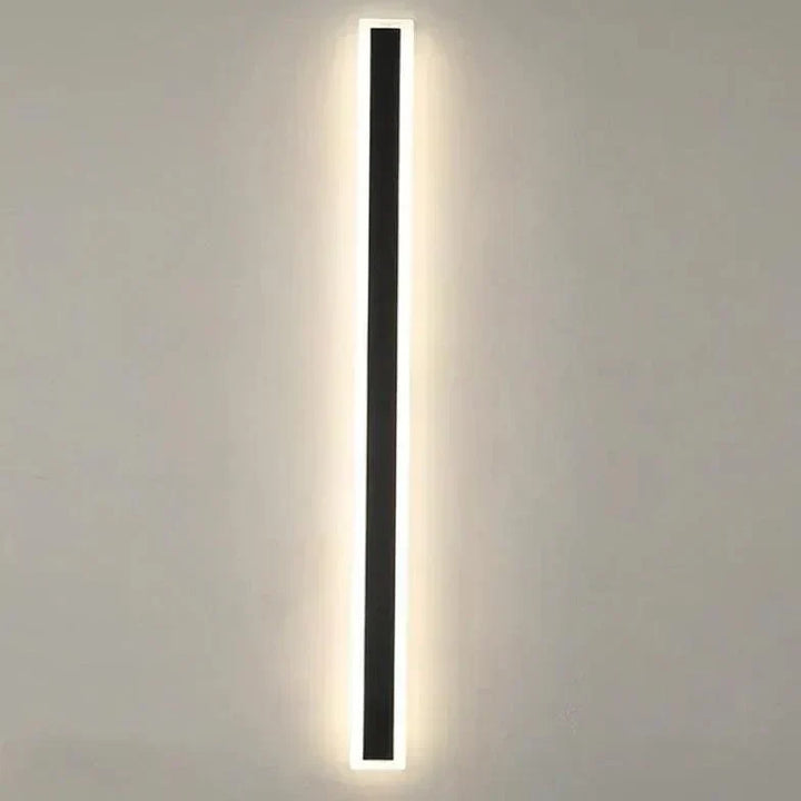 Modern LED exterior wall light installed on a home's patio, providing warm, dimmable outdoor garden illumination.