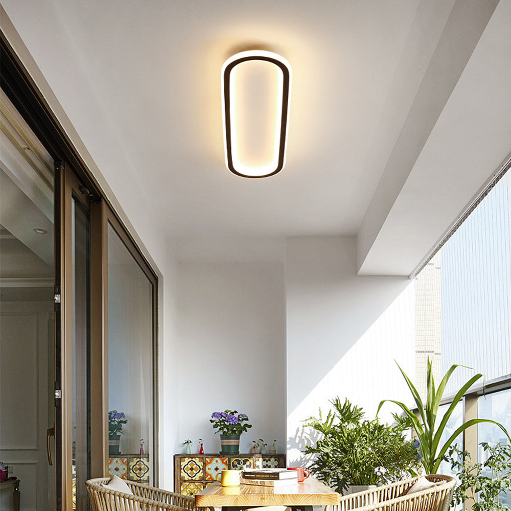 Oval LED flush mount ceiling light with an adjustable glow, suited for modern interiors.