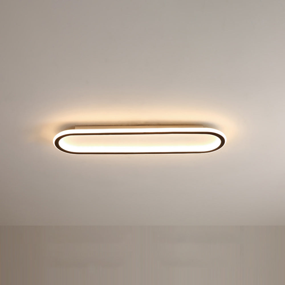 Contemporary oval flush mount ceiling light, sleek black design for modern homes.