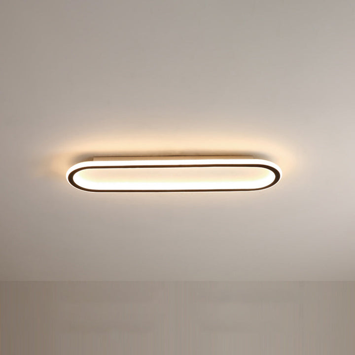 Contemporary oval flush mount ceiling light, sleek black design for modern homes.