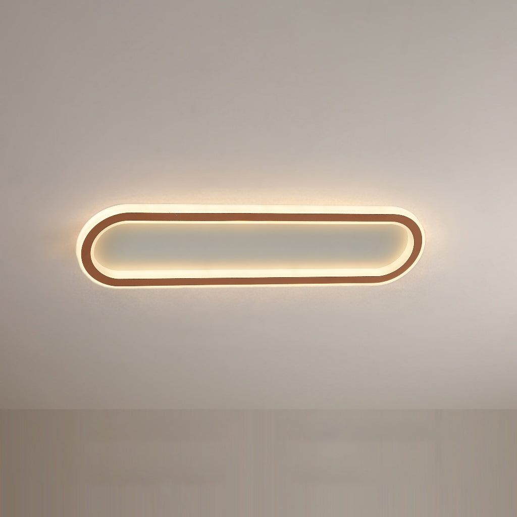 Sleek rose gold oval flush mount ceiling light, adding a stylish touch to any room.