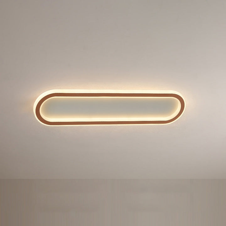 Sleek rose gold oval flush mount ceiling light, adding a stylish touch to any room.