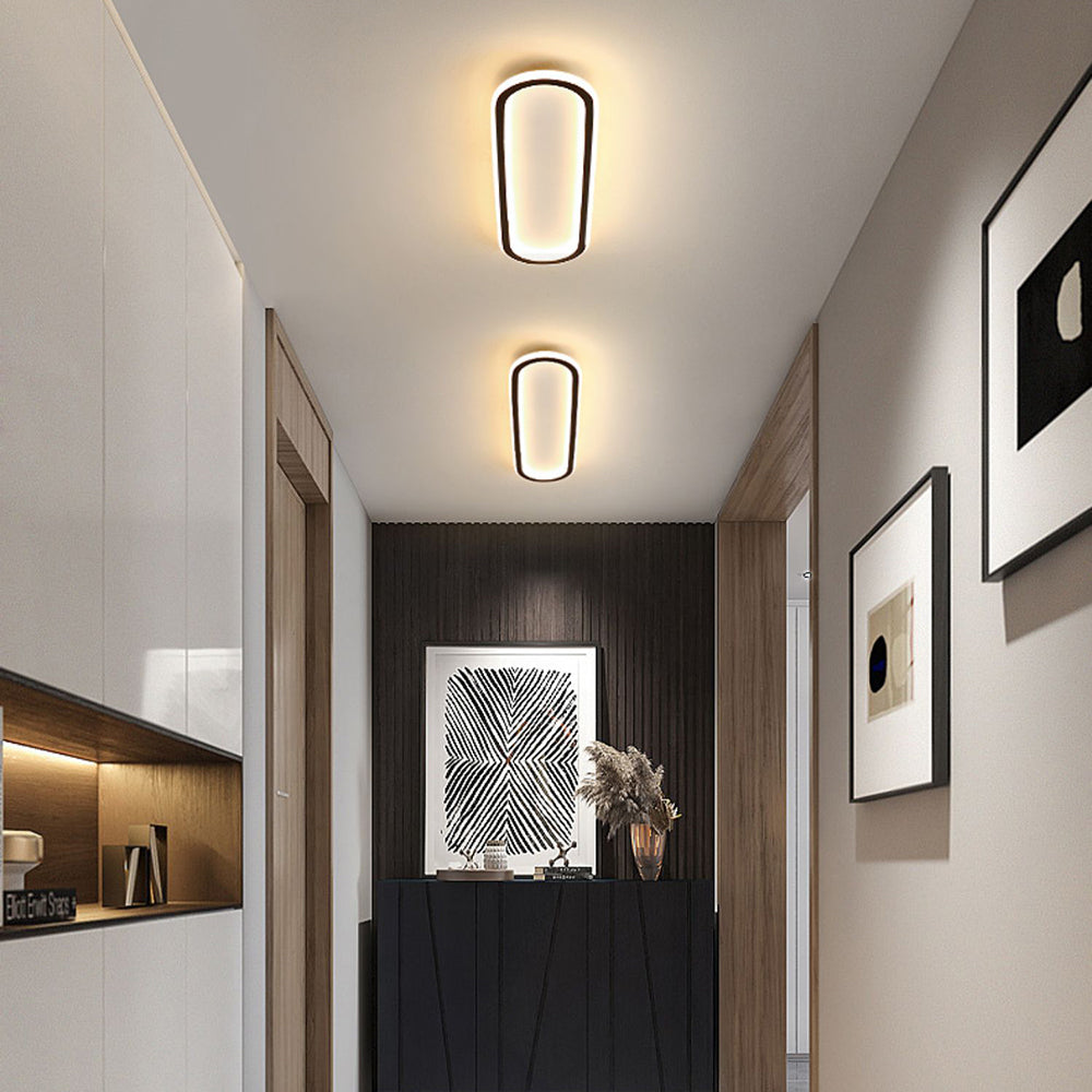 Contemporary oval flush mount ceiling light with adjustable LED for modern decor.