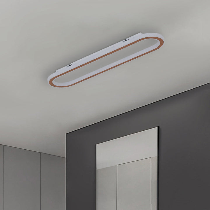 Sleek oval ceiling light, flush mount design, with energy-efficient LED lighting.