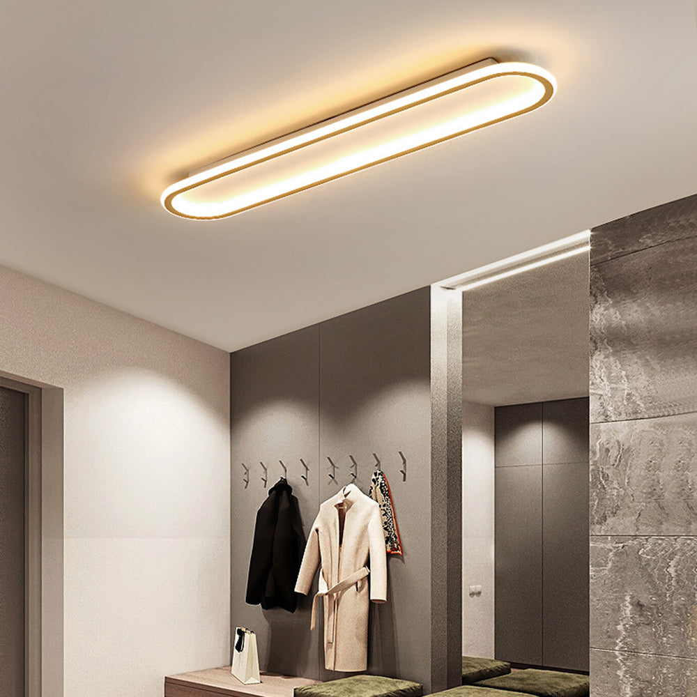 Elegant gold oval LED flush mount ceiling light, perfect for modern home decor.