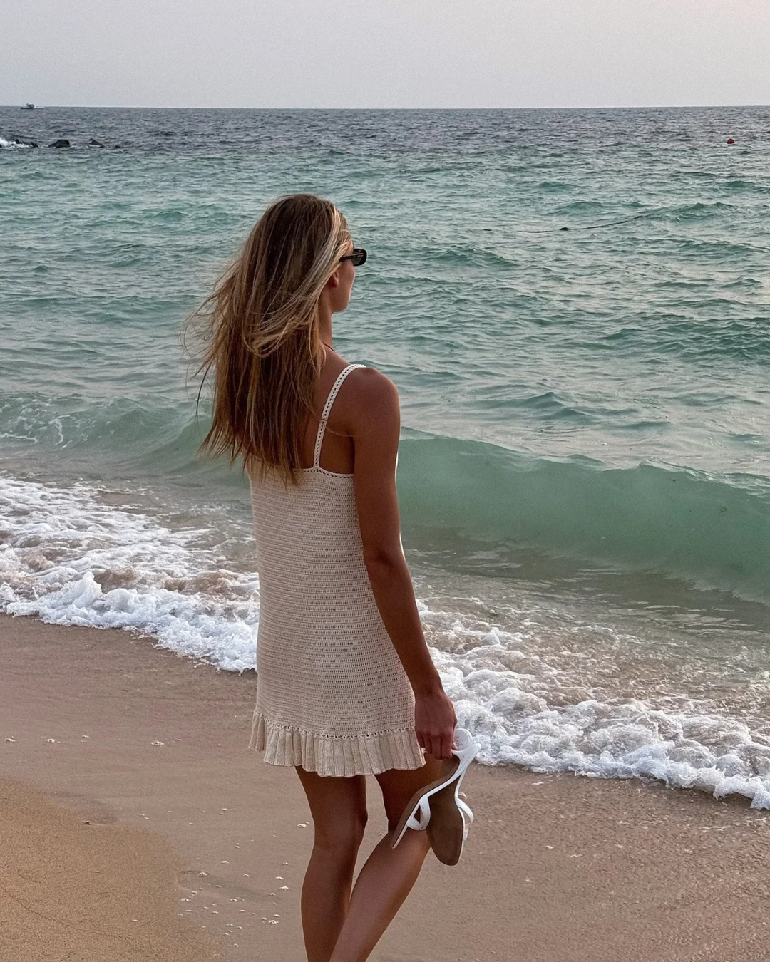 Casual women's bohemian frill mini dress, great for beach, vacation, or summer wear. Sleeveless V-neck design.