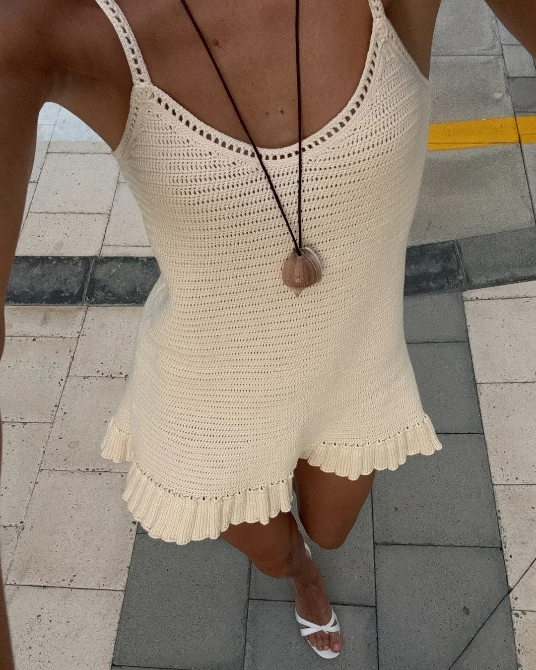 Stylish sleeveless V-neck bohemian mini dress for women, featuring a frill hem. Perfect for summer & vacation.
