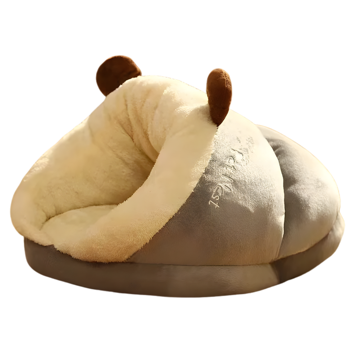 A cat nestled inside the SnugBug cozy pet hideaway bed, demonstrating its snuggle appeal.