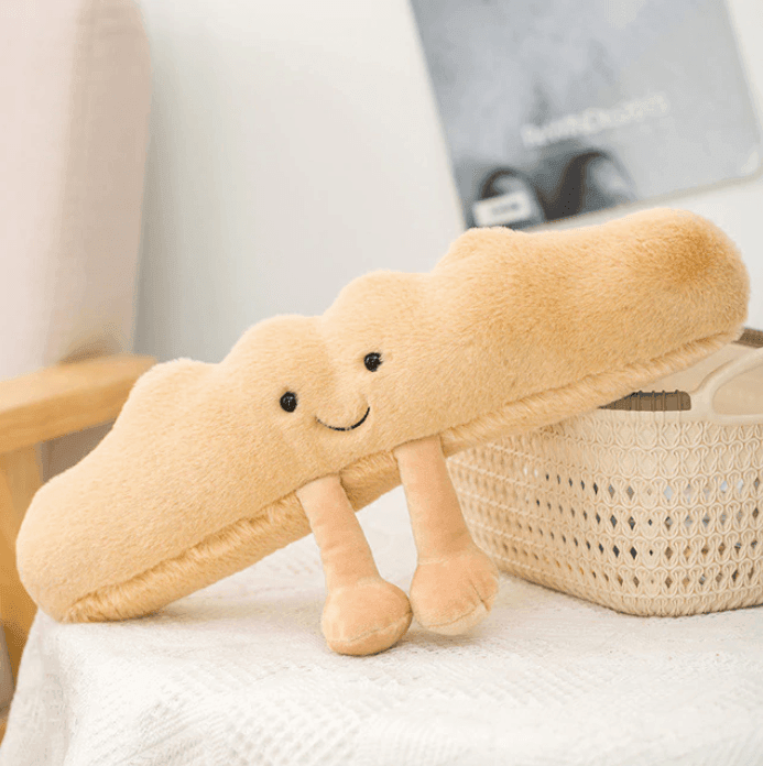 Soft croissant plush toy, a huggable comfort buddy for kids and adults.