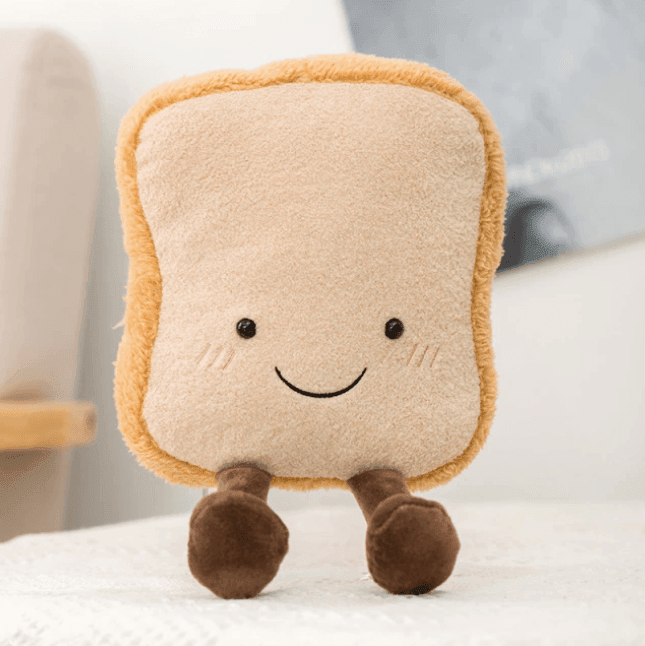 Close-up of a fluffy croissant plush toy, showing its soft texture and cute design.