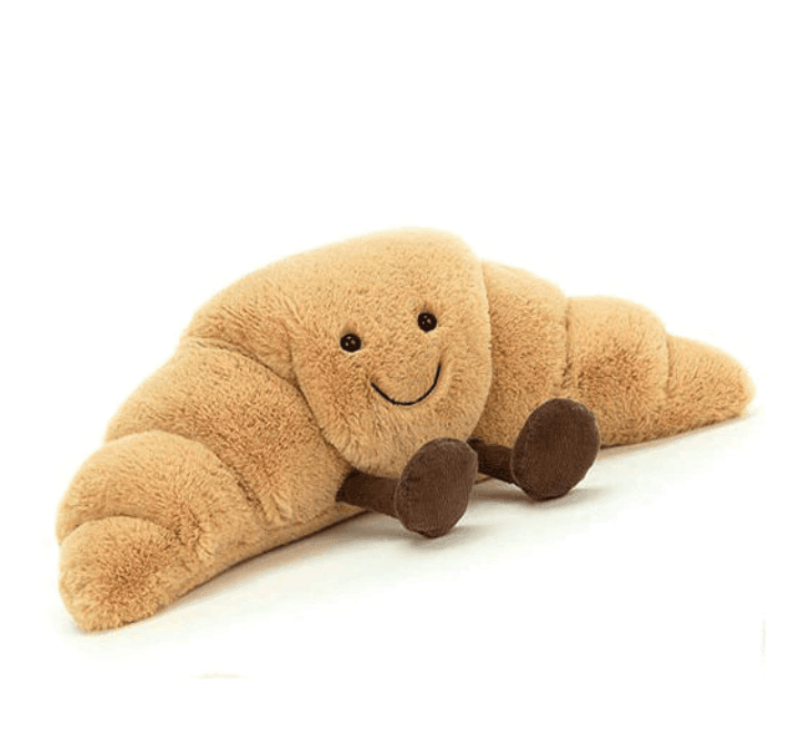 Cozy bread plush toy shaped like a croissant, ideal for home decor and comfort.