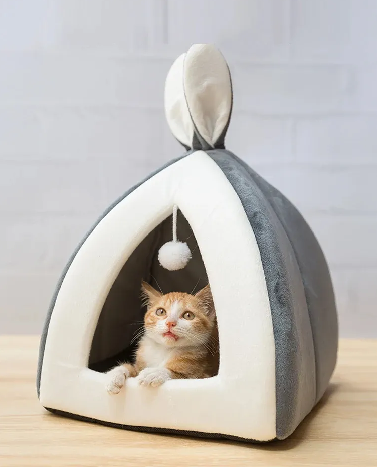 Soft gray cave cat bed with integrated play ball, perfect for cozy feline comfort & play.