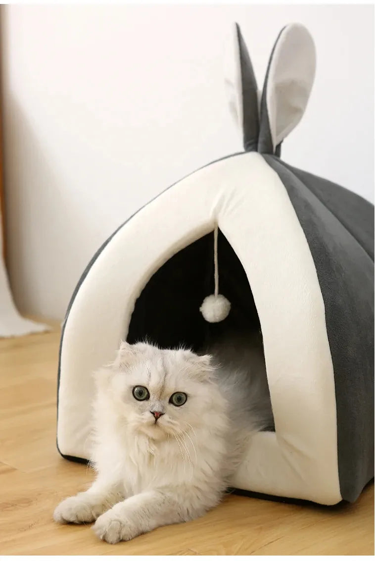 Cuddly rosa cave pet bed for cats & kittens, featuring a built-in play ball for hours of fun.