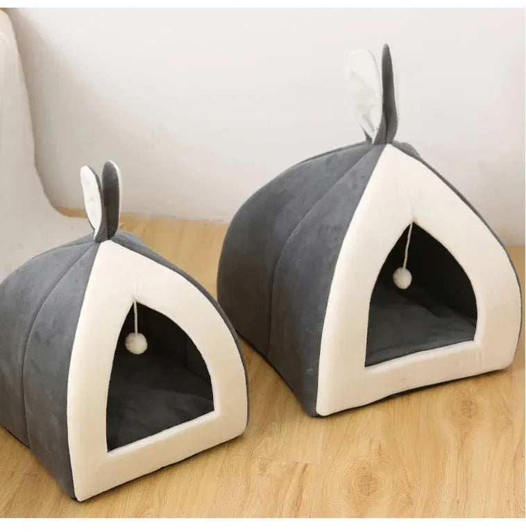 Washable cozy cave cat bed in soft gray, offering a comfortable hideaway & attached toy ball.