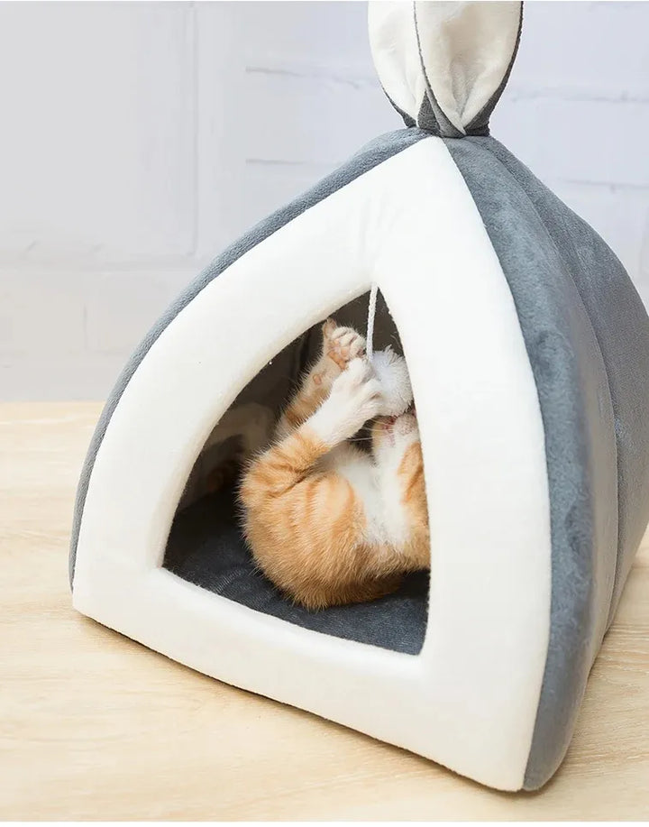 Feline comfort: luxurious soft cave cat bed with a dangling play ball, ideal for napping & play.