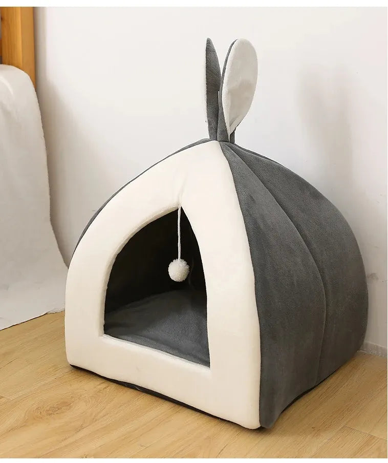 Deep gray cave cat bed, super soft and cozy, featuring a fun integrated play ball for playful cats.