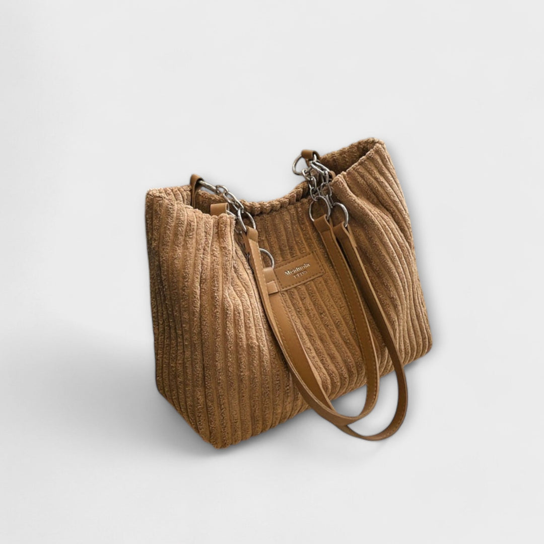 Black corduroy shoulder bag for women, easily converts to a stylish crossbody for everyday wear.