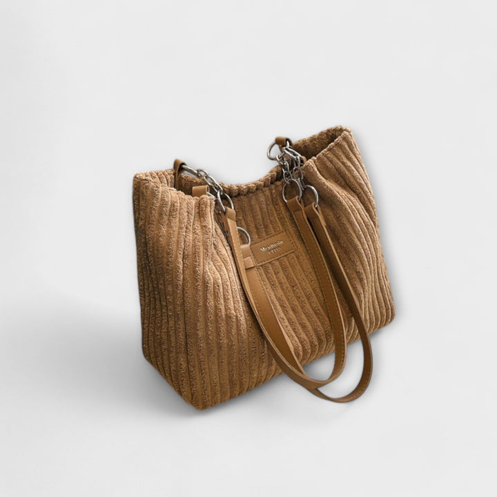 Black corduroy shoulder bag for women, easily converts to a stylish crossbody for everyday wear.