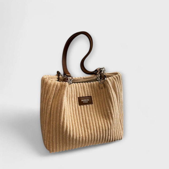 Close-up of a soft beige corduroy shoulder bag, highlighting the cozy fabric for women's casual style.