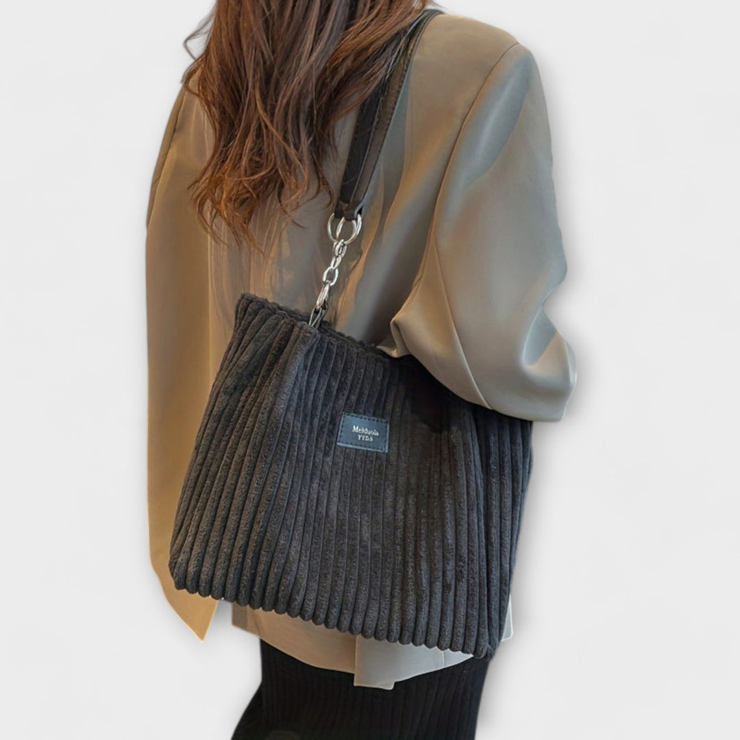 Stylish black corduroy shoulder bag for women, a soft and practical everyday fashion accessory.