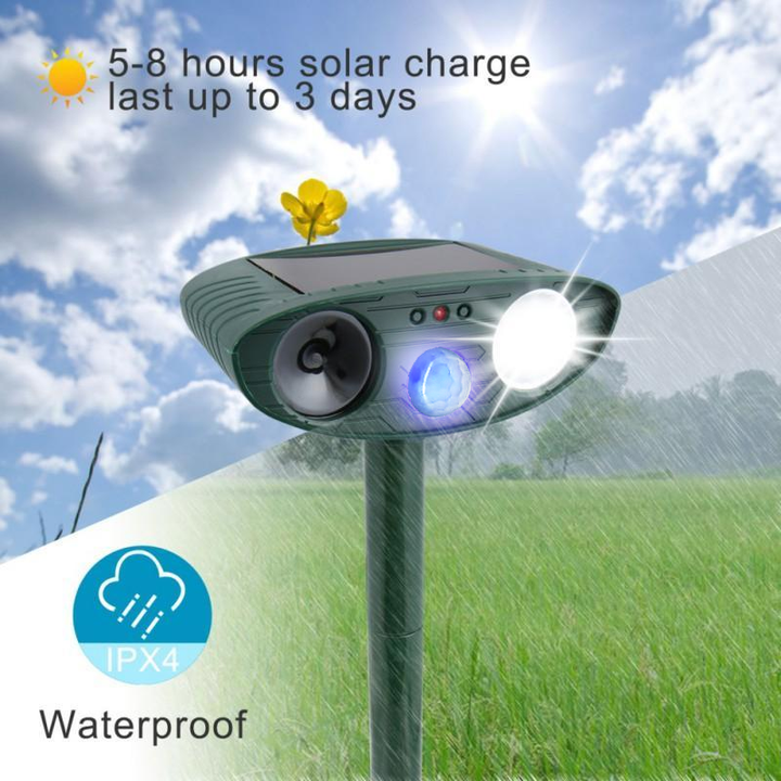 Solar ultrasonic deer repeller installed in a garden bed. Effective pest control for plants.