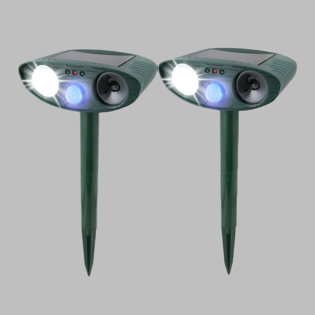 Solar rabbit repeller installed in a vibrant garden bed, providing eco-friendly plant protection.
