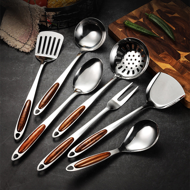 Stainless steel kitchen utensil set with ergonomic wooden handles. Essential cooking tools for home cooks & gourmet chefs.