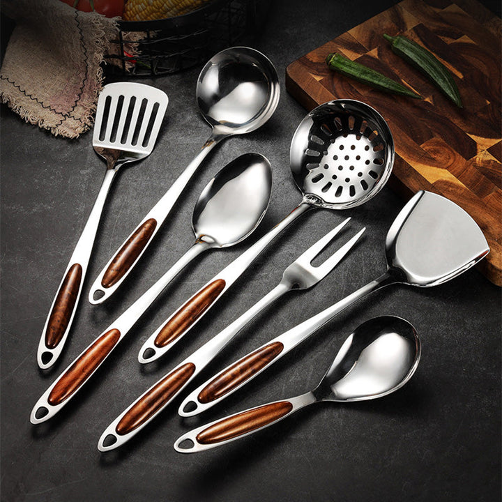 Stainless steel kitchen utensil set with ergonomic wooden handles. Essential cooking tools for home cooks & gourmet chefs.